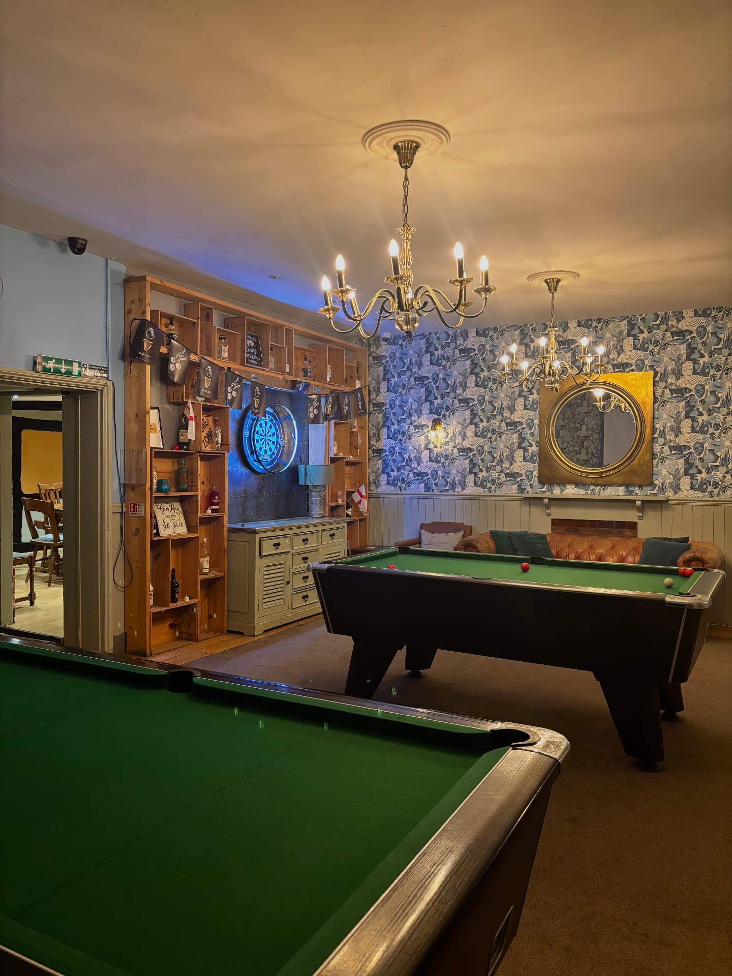 The games room at The Fox — pool tables, darts and chandeliers